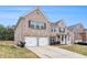 Attractive brick home featuring a spacious two-car garage, landscaped front yard and well-maintained lawn at 2036 Broadmoor Way, Fairburn, GA 30213