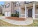 Close-up of a charming front porch with white pillars, well-kept bushes and a tidy yard at 2036 Broadmoor Way, Fairburn, GA 30213