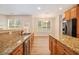 Well-equipped kitchen featuring granite countertops, wood cabinets, modern appliances, and an open layout at 2036 Broadmoor Way, Fairburn, GA 30213