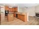 Open kitchen with granite countertops and island seamlessly connected to a cozy living area at 2036 Broadmoor Way, Fairburn, GA 30213