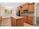 Modern kitchen with granite countertops, wood cabinets, stainless steel appliances, and center island at 2036 Broadmoor Way, Fairburn, GA 30213