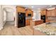 Bright kitchen featuring granite countertops, wood cabinets, a kitchen island, and stainless steel appliances at 2036 Broadmoor Way, Fairburn, GA 30213