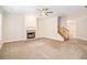 Spacious living room with neutral carpet, a fireplace, and a staircase leading to the upper floor at 2036 Broadmoor Way, Fairburn, GA 30213