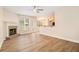 Inviting living room featuring a brick fireplace, large windows, and seamless access to the kitchen at 2036 Broadmoor Way, Fairburn, GA 30213
