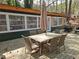 Spacious outdoor deck with dining table and seating, perfect for entertaining surrounded by mature trees at 5440 Portside Dr, Acworth, GA 30101
