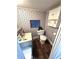 Compact bathroom showcasing floral wallpaper, vanity, and toilet at 5440 Portside Dr, Acworth, GA 30101