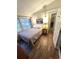 Cozy bedroom with a double bed, bedside table, wall sconces, and a view of the outside at 5440 Portside Dr, Acworth, GA 30101
