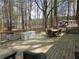 Large wooden deck with patio furniture and wooded view at 5440 Portside Dr, Acworth, GA 30101