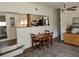 Cozy dining area with wood table, ceiling fan, and view to the kitchen and bathroom at 5440 Portside Dr, Acworth, GA 30101