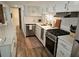 Modern kitchen with stainless steel appliances, granite countertops, and white cabinetry at 5440 Portside Dr, Acworth, GA 30101