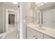 Bright bathroom featuring a white single sink vanity, large mirror, and tiled floors at 1662 Hartford Ne Gln, Atlanta, GA 30319
