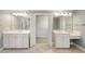 Bright bathroom with dual sinks, white cabinetry, and entry to walk-in closet at 1662 Hartford Ne Gln, Atlanta, GA 30319