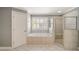 Bathroom features a soaking tub, tiled shower, and ample natural light from window at 1662 Hartford Ne Gln, Atlanta, GA 30319