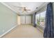 Spacious bedroom features a ceiling fan, two closets, and a large window with blinds and curtains at 1662 Hartford Ne Gln, Atlanta, GA 30319