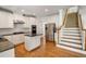 Spacious kitchen features stainless steel appliances, white cabinets, and granite countertops at 1662 Hartford Ne Gln, Atlanta, GA 30319