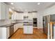 Modern kitchen with stainless steel appliances, white cabinets, and hardwood floors at 1662 Hartford Ne Gln, Atlanta, GA 30319