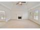 Bright living room with a fireplace, large windows, and neutral carpet at 1662 Hartford Ne Gln, Atlanta, GA 30319