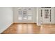 Sun-drenched living room with hardwood floors, white trim, and arched windows at 1662 Hartford Ne Gln, Atlanta, GA 30319