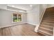 Living area featuring hardwood flooring, a window, and a staircase at 1662 Hartford Ne Gln, Atlanta, GA 30319