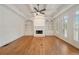 Bright living room featuring a fireplace, built-in shelving, coffered ceiling and hardwood floors at 1662 Hartford Ne Gln, Atlanta, GA 30319