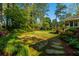 Well maintained backyard with lush landscaping, mature trees, a gazebo, and a stepping stone walkway at 2972 Ponderosa Cir, Decatur, GA 30033