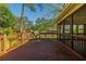 Backyard wooden deck with steps to the lawn plus views of a screened porch area at 2972 Ponderosa Cir, Decatur, GA 30033