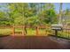 Spacious backyard deck featuring a grill, wood railing, and stairs with beautiful landscaping at 2972 Ponderosa Cir, Decatur, GA 30033