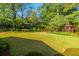Green backyard with mature trees and landscaping featuring a gazebo surrounded by foliage at 2972 Ponderosa Cir, Decatur, GA 30033