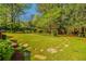 Backyard with lush lawn, stone pavers, gazebo, and play set, creating an inviting space at 2972 Ponderosa Cir, Decatur, GA 30033