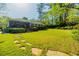 Lush backyard with stone walkway, stairs to deck, and mature trees creates a private oasis at 2972 Ponderosa Cir, Decatur, GA 30033