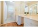 Bright bathroom featuring an extended vanity with storage and large mirror, complemented by tile flooring at 2972 Ponderosa Cir, Decatur, GA 30033