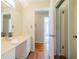 Bright bathroom with a long vanity, large mirror, wood flooring, and a shower with sliding glass doors at 2972 Ponderosa Cir, Decatur, GA 30033