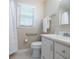 Updated bathroom featuring white vanity, tile flooring, updated fixtures, and accessible grab bars at 2972 Ponderosa Cir, Decatur, GA 30033