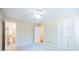 Spacious bedroom with ceiling fan, neutral walls, carpet, and access to a bathroom at 2972 Ponderosa Cir, Decatur, GA 30033
