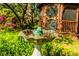 Close up of a stone bird bath with a decorative bird and a gazebo in the background at 2972 Ponderosa Cir, Decatur, GA 30033
