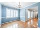 Traditional dining room boasts hardwood floors, chandelier, wainscoting and white trim with blue walls at 2972 Ponderosa Cir, Decatur, GA 30033