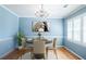 Traditional dining room boasts hardwood floors, chandelier, and wainscoting with blue walls, seating for four at 2972 Ponderosa Cir, Decatur, GA 30033