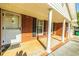 Inviting front porch with brick columns and black shuttered windows at 2972 Ponderosa Cir, Decatur, GA 30033
