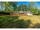 Charming single-story brick home featuring a well-manicured lawn and colorful flower beds at 2972 Ponderosa Cir, Decatur, GA 30033