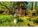 Lush backyard view with bird bath, screened gazebo, and play structure at 2972 Ponderosa Cir, Decatur, GA 30033
