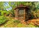 Angled exterior view of a screened wooden gazebo in a landscaped backyard at 2972 Ponderosa Cir, Decatur, GA 30033