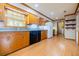 Eat-in kitchen with breakfast nook, laminate floors, wood cabinets, and black appliances at 2972 Ponderosa Cir, Decatur, GA 30033