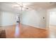 Living room with wood floors and brick fireplace offering access to bathroom and foyer at 2972 Ponderosa Cir, Decatur, GA 30033