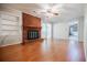 Cozy living room featuring a brick fireplace and light hardwood flooring at 2972 Ponderosa Cir, Decatur, GA 30033