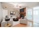 Stylish living room features a brick fireplace, white couches, and a view of the sunroom at 2972 Ponderosa Cir, Decatur, GA 30033