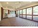 Spacious screened-in porch with wood flooring, large windows, and a view of the outdoor greenery at 2972 Ponderosa Cir, Decatur, GA 30033