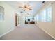Sunroom with neutral carpet, ceiling fans, and lots of natural light from many windows at 2972 Ponderosa Cir, Decatur, GA 30033