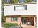 Charming townhouse featuring brick and siding facade, complemented by black shutters and a cozy front porch at 3346 Northcrest Rd # A, Atlanta, GA 30340