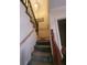 Carpeted staircase with decorative wood banister leads to upper level of home at 3346 Northcrest Rd # A, Atlanta, GA 30340