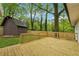 Wooden deck in a grassy backyard with a shed at 1232 Andrews Dr, Marietta, GA 30062